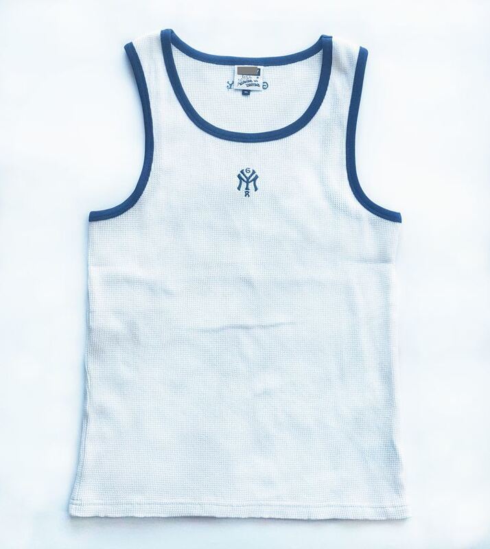 Mens tanktop featuring 100 percent cotton waffle fabric body solid color with contrast color rib piping around neck and armhole